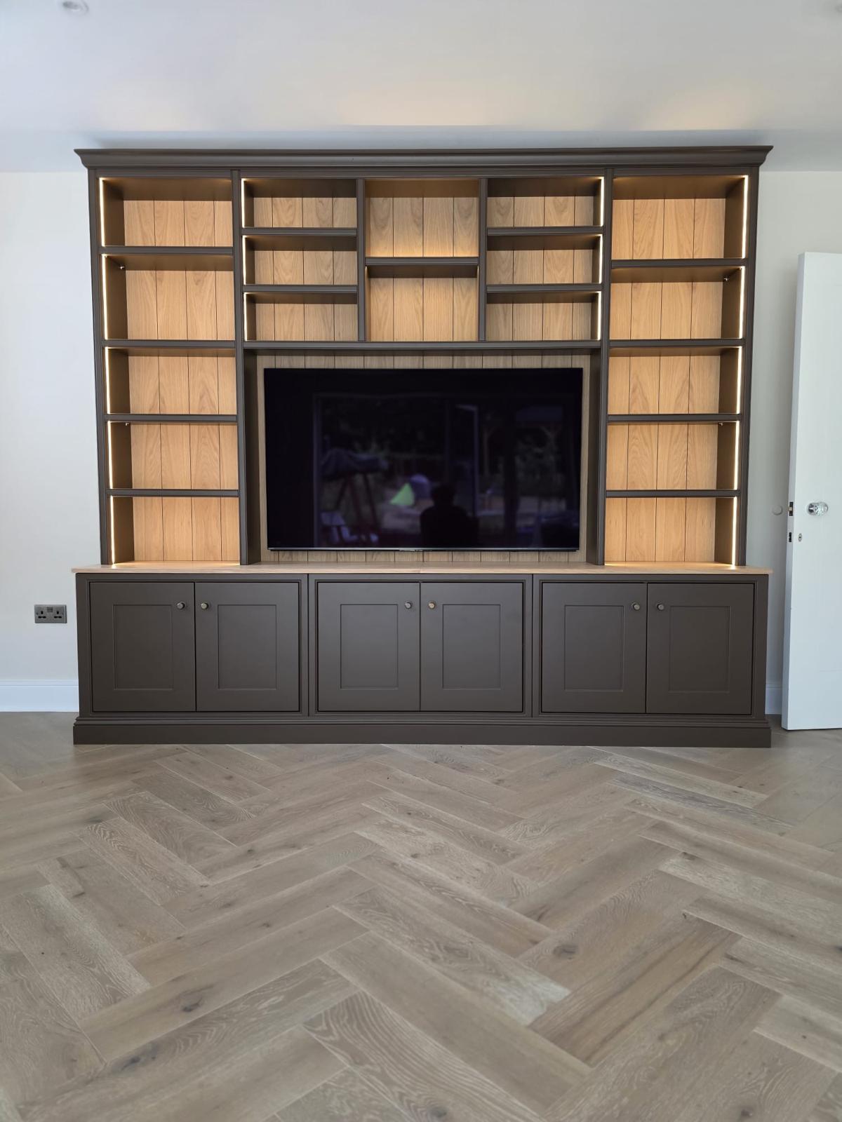 Large bespoke media wall library unit in mocha paint with oak backs