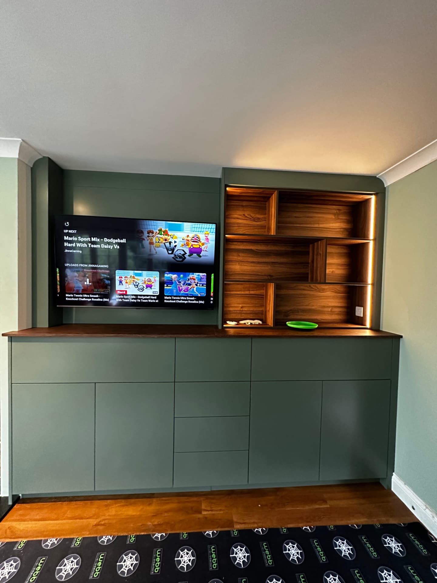 Bespoke media unit in sage green with walnut display shelving